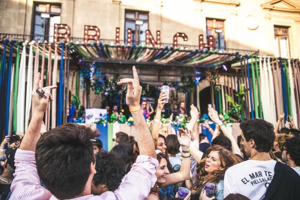 People dancing in front of brunch sign.