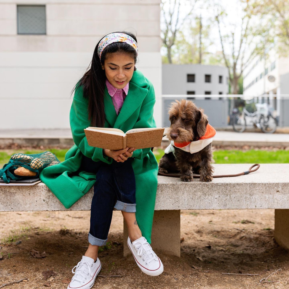 Student with dog, studying.