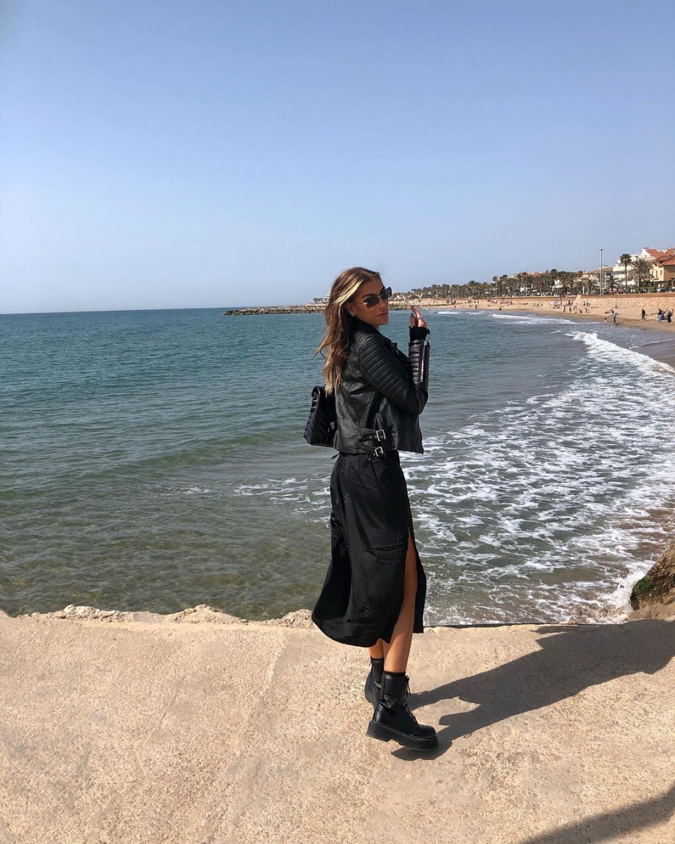 Girl standing in front of the sea.