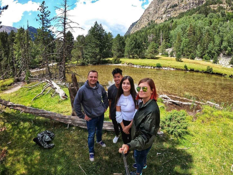 4 people standing in the mountains.