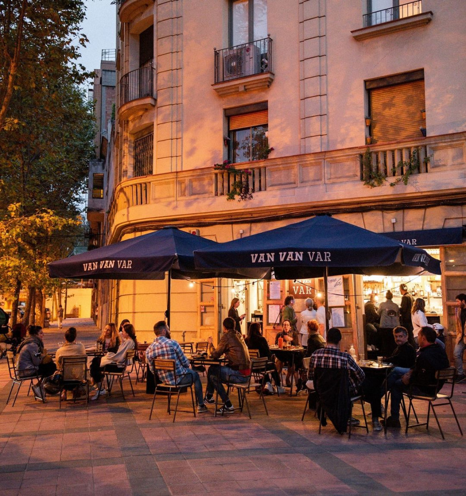 Night time image of people sitting at a bar.
