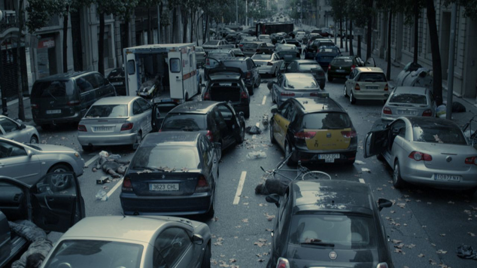 A Barcelona street with abandoned cars.